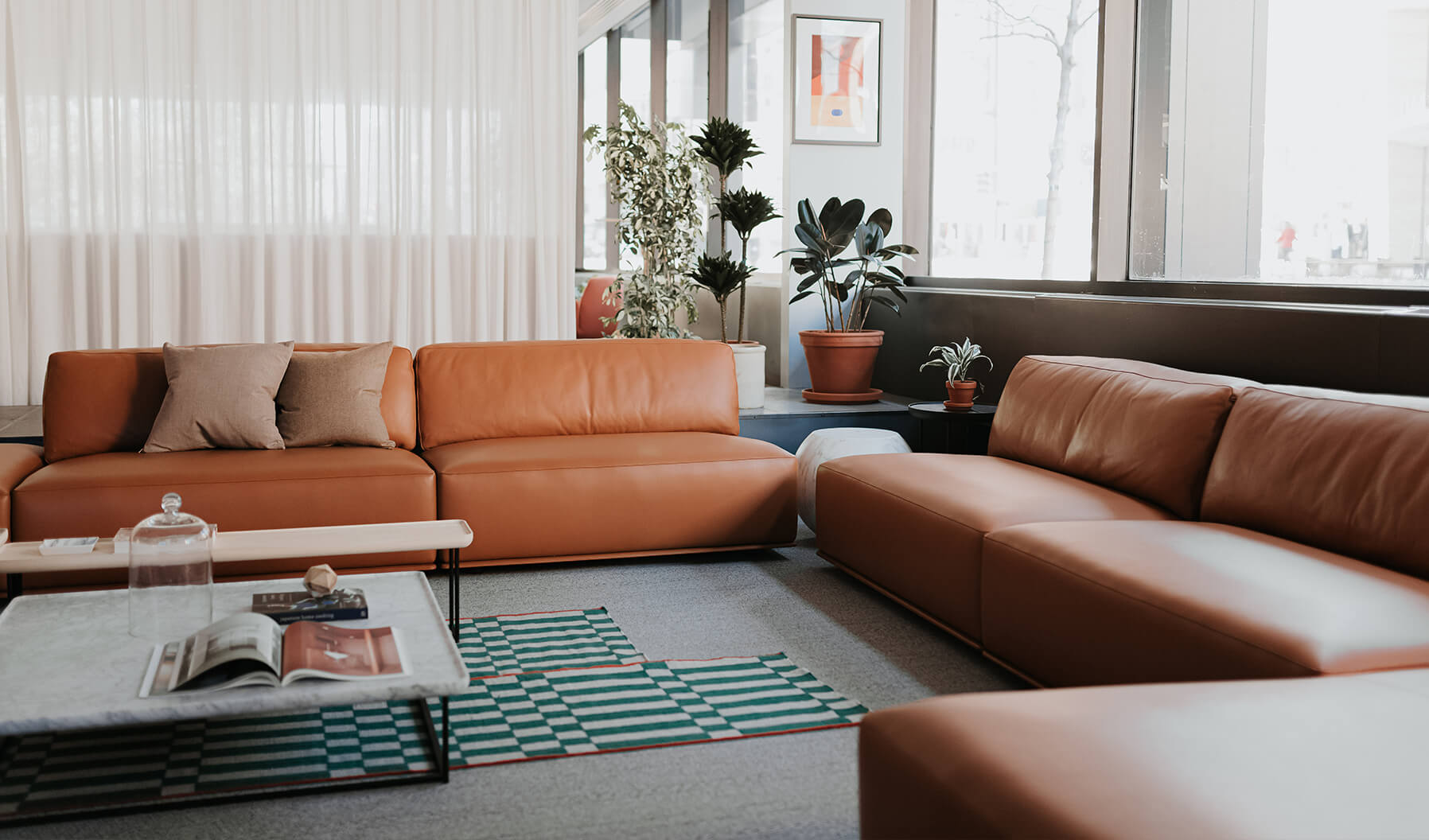 This lounge creates a Social Space that provides comfortable seating to
encourage interaction and collaboration with relaxed, seated postures.  Gan Rugs, Cassina side tables, pillows, and plants contribute to the
ambience.