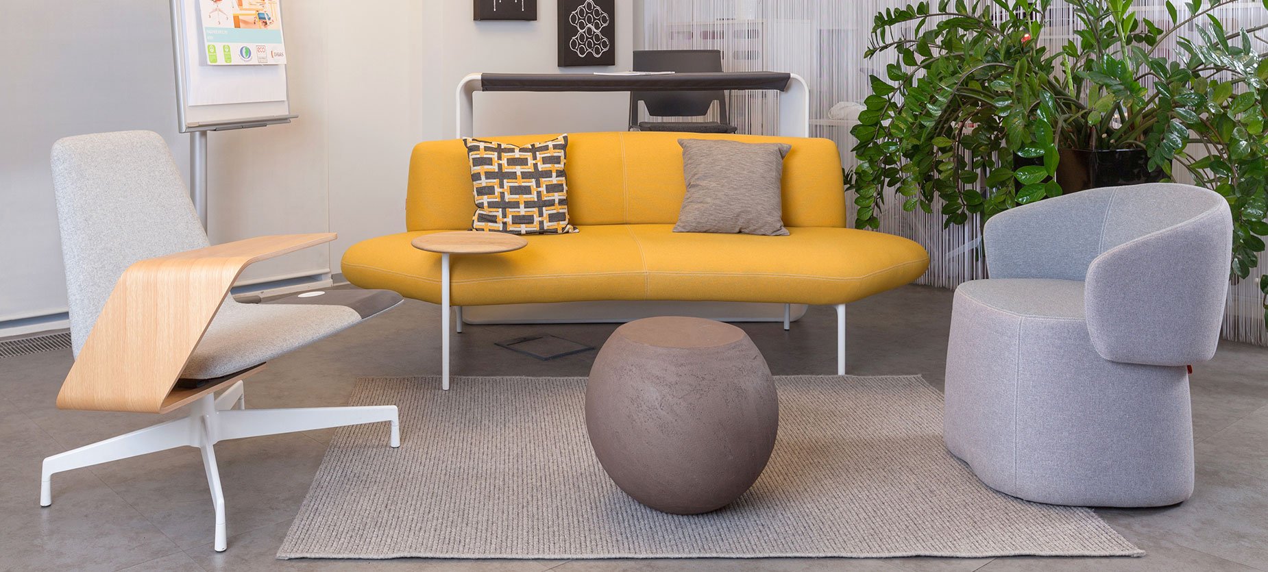A cozy lounge area is furnished with an inviting combination of a Chick pouf, Feather sofa, Harbor Work Lounge, and Cappellini's Bong coffee table. 

By simply moving the flip board to the opposite wall and adding a few guest chairs, this area easily transforms into a training zone.