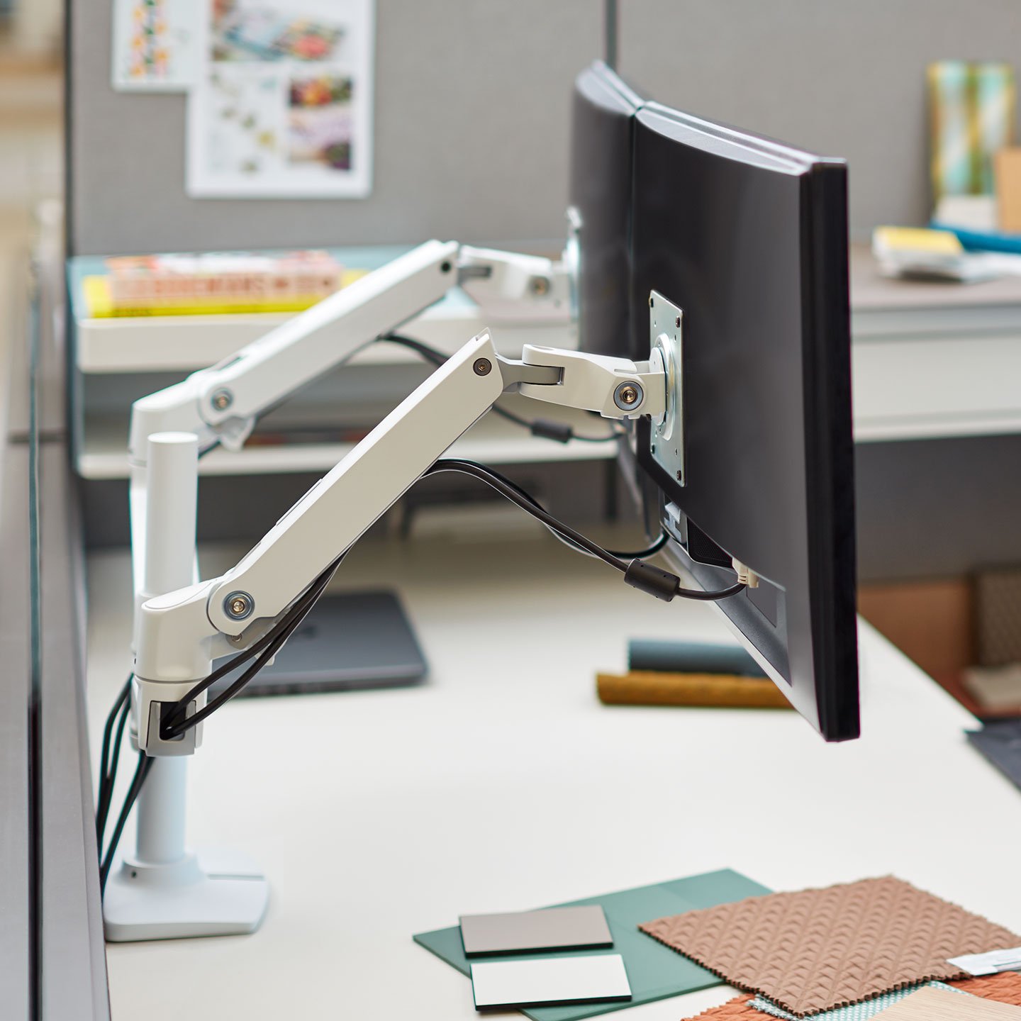Haworth Monitor Arm Accessories at a desk space with dual monitors and a magazine 