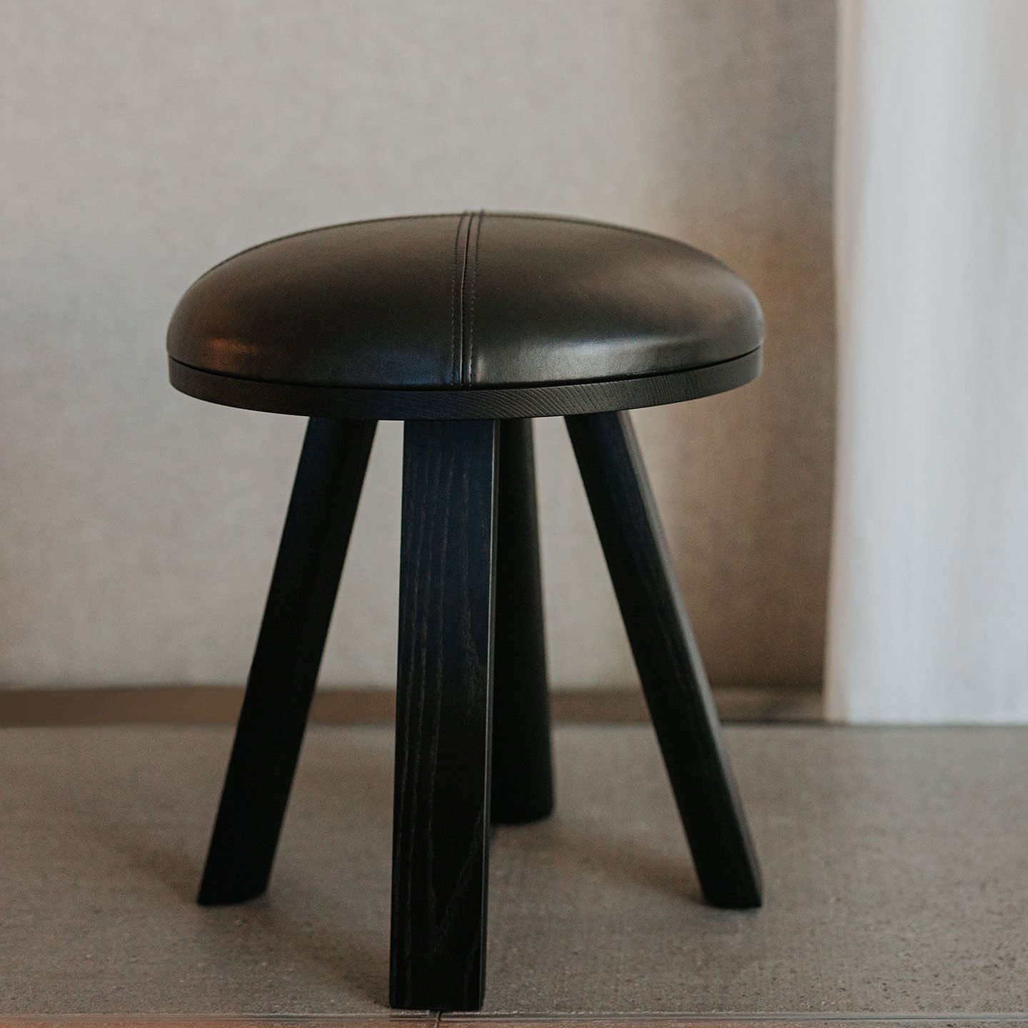 Haworth BuzziMilk stool in black leather and wood