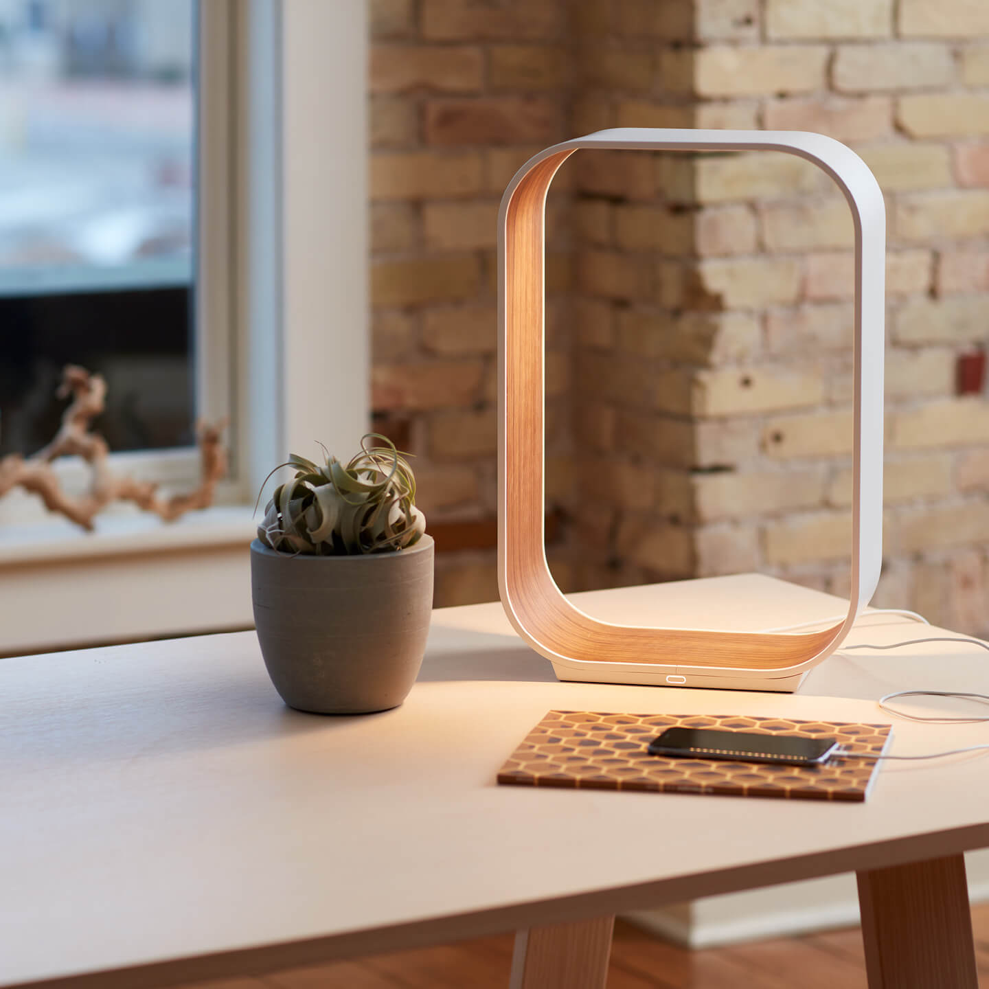 Haworth Pablo Pardo designer lamp on office desk with plant and phone on desk