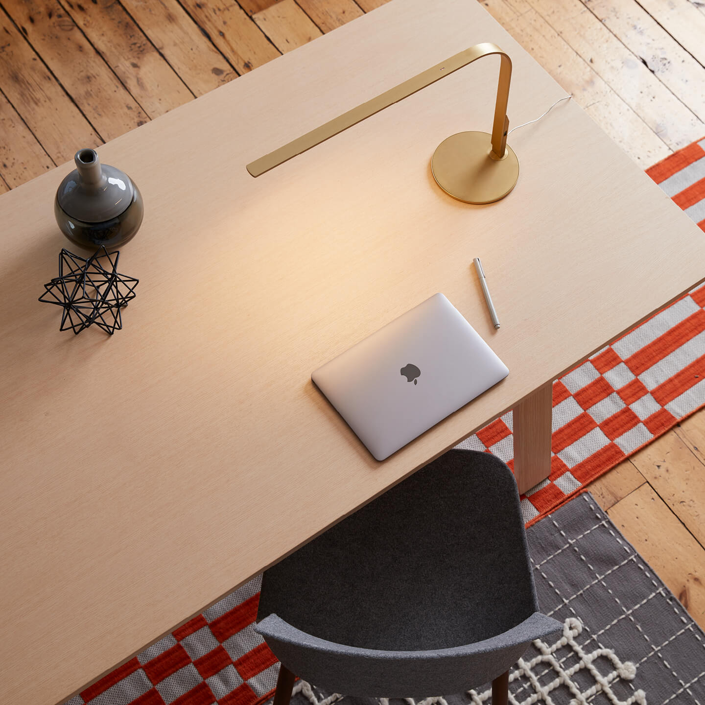 Haworth Pablo Pardo Designer gold lamp on wooden desk with laptop on it and grey chair