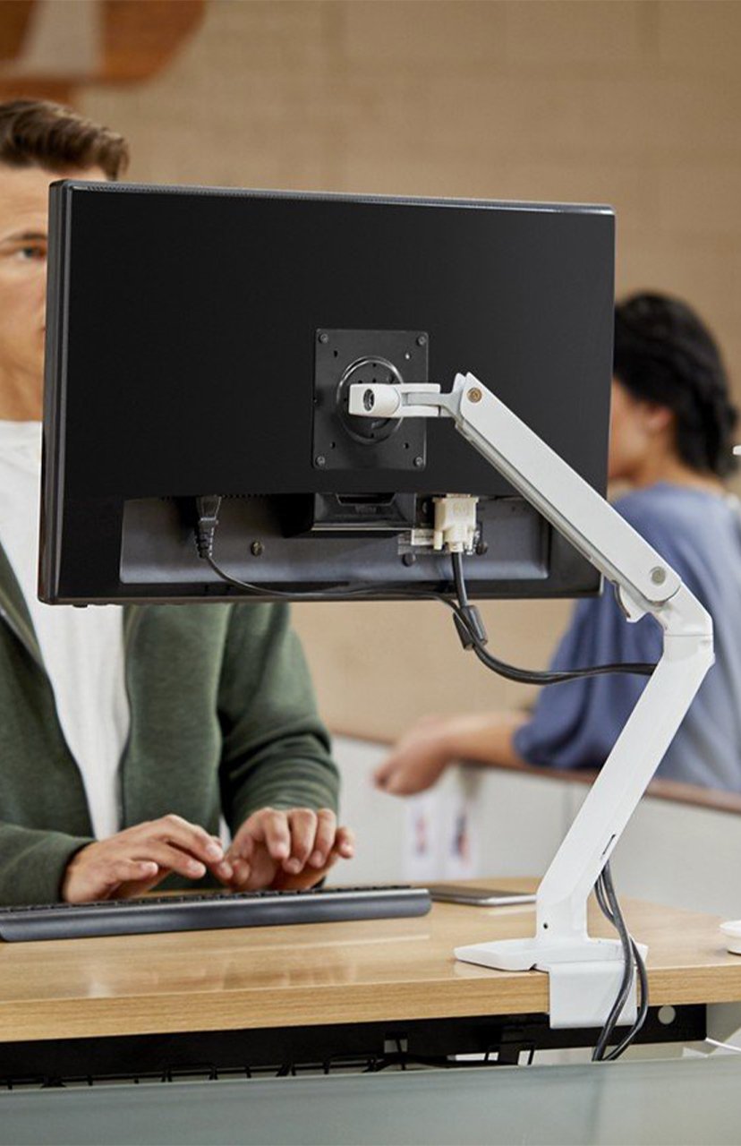 Haworth Ergotron monitor arms attached to a monitor  in an office