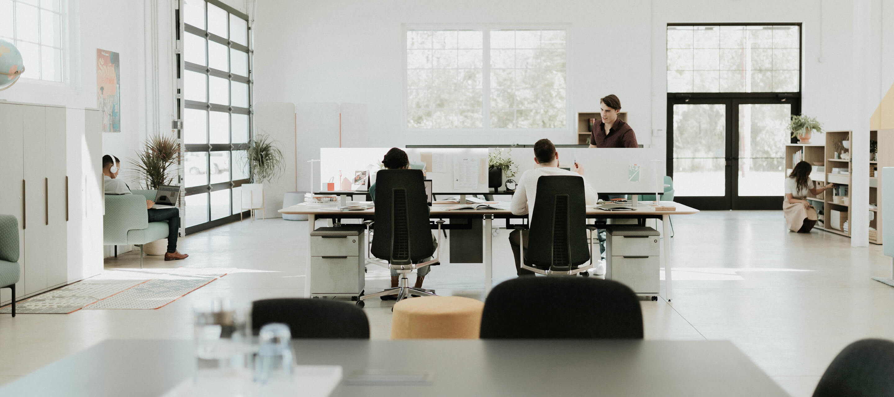  Open office workspace featuring fern chairs and compose storage.