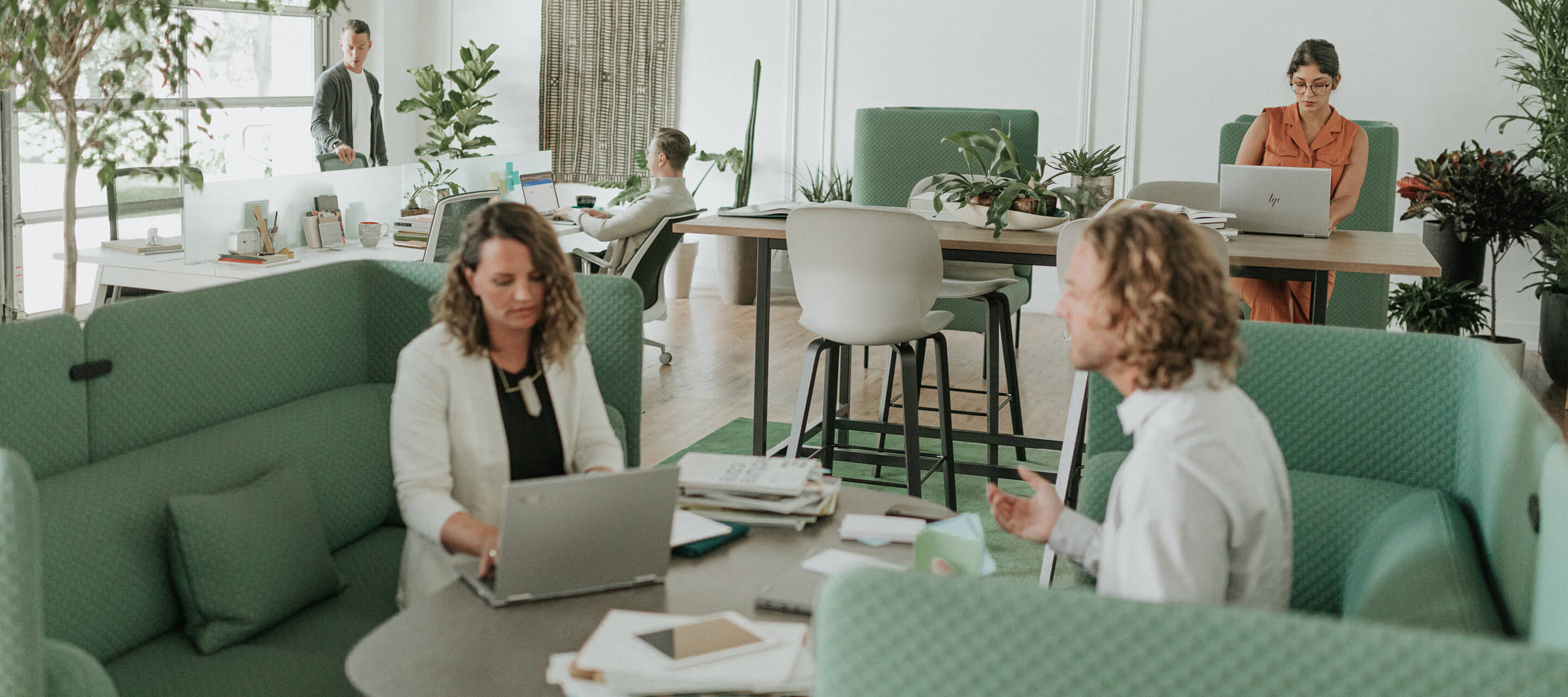 Two employees working together in a lounge area./