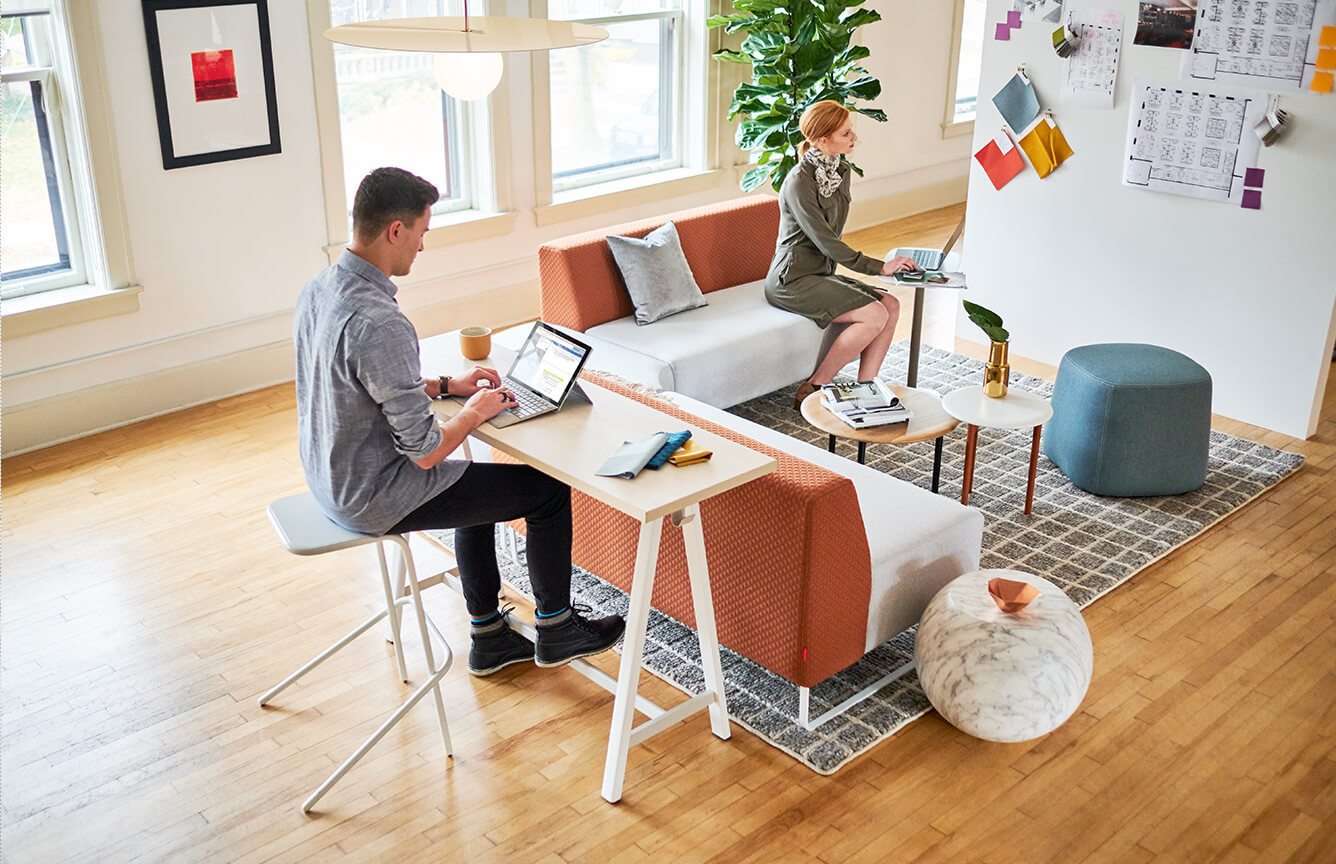 Lounge space featuring Pop up table and River Bend and Pebble office sectional.