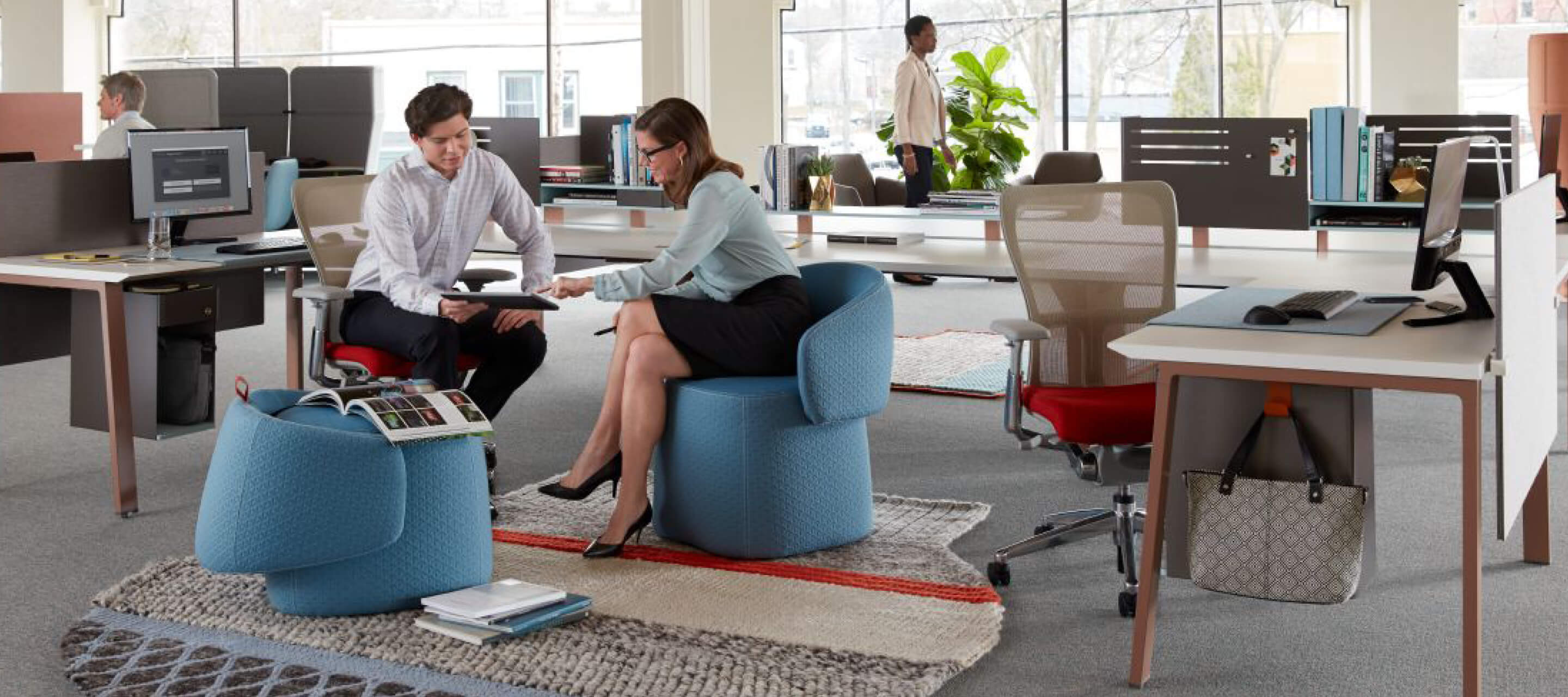 Employees collaborating over openest chick pouf  and mangas original rug.