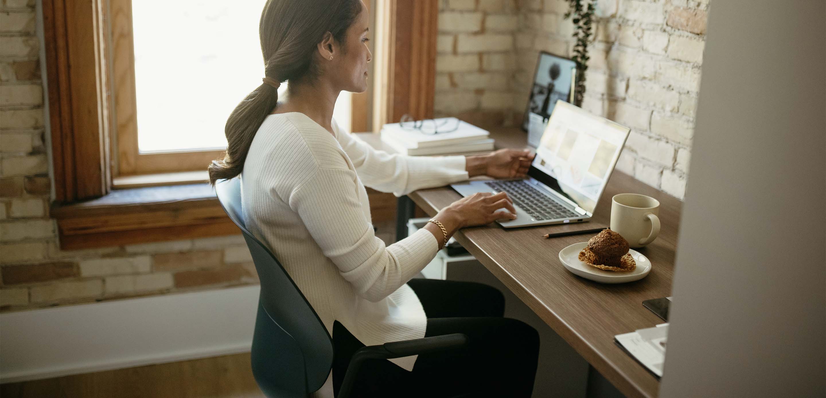 A Haworth employee working from home using Haworth chair and desk