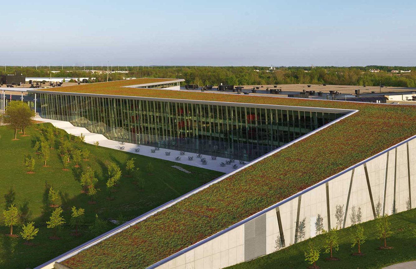 A building with sloped terrace amidst greenery