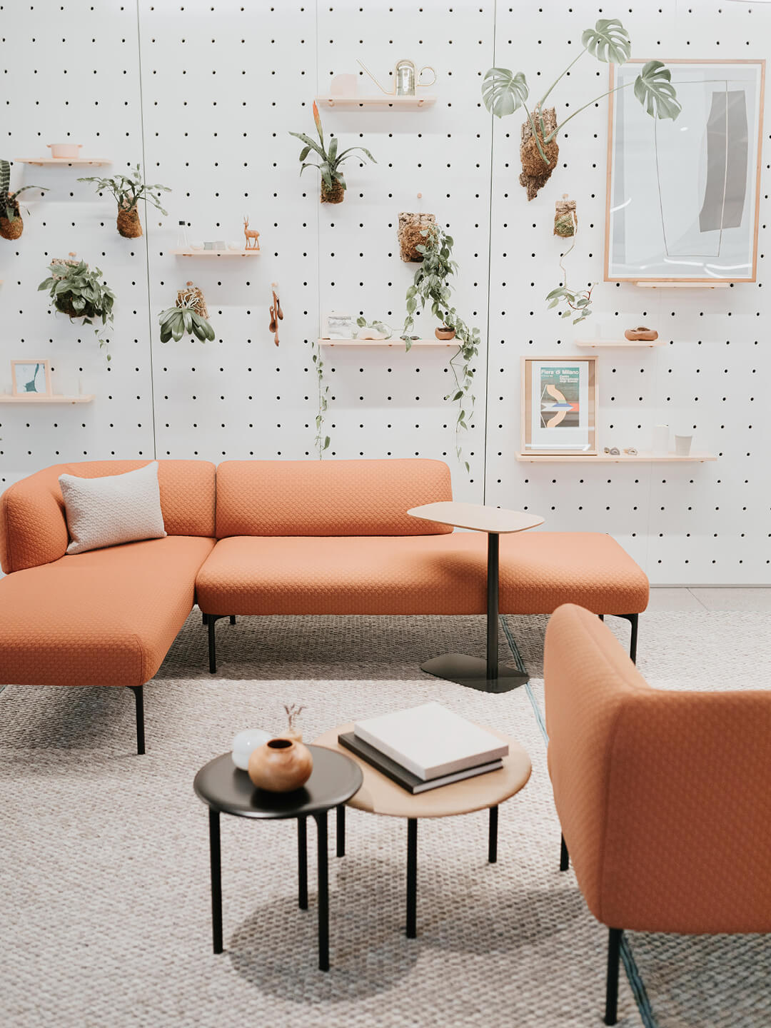 Lounge space featuring pip laptop tables with plants hanging in the background