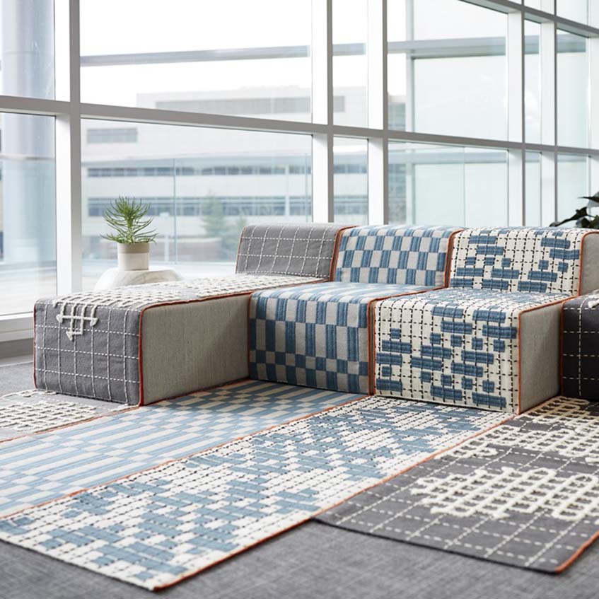 GAN rugs in blue, grey, offwhite colors in a room