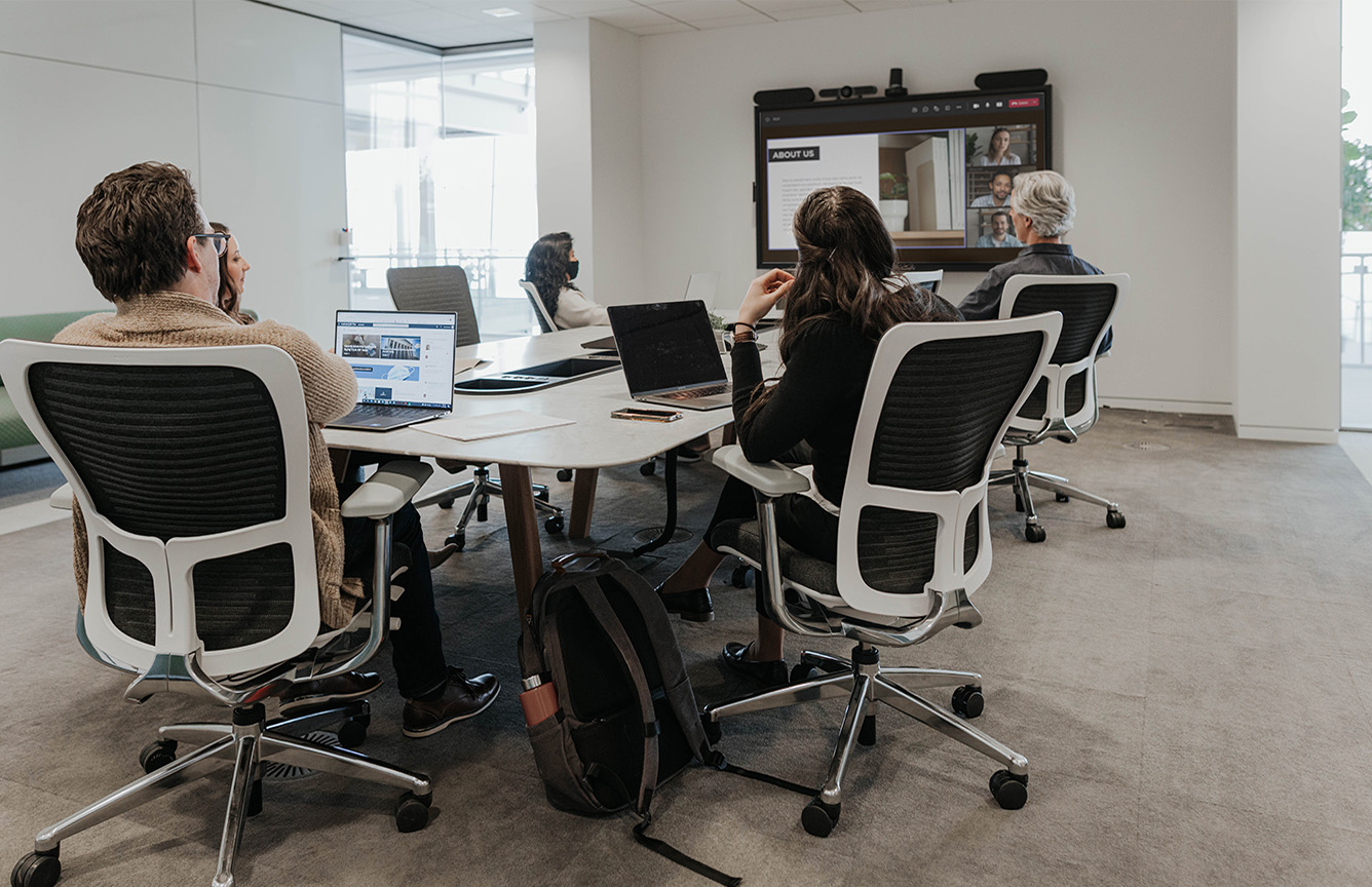 Haworth Zody chair in black and white in a conference room view 10