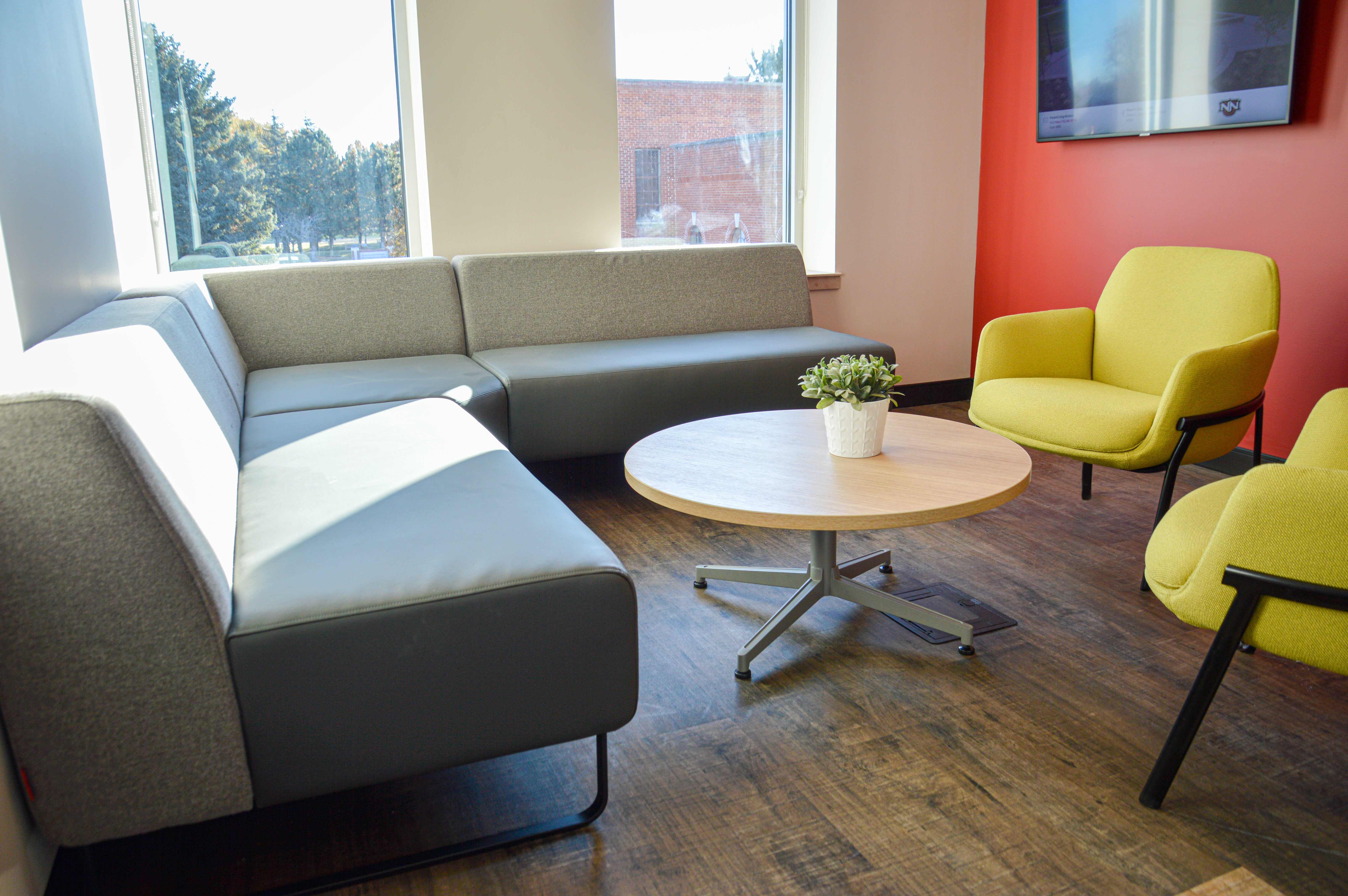 Haworth Poppy chair in yellow and Cabana lounge in a room