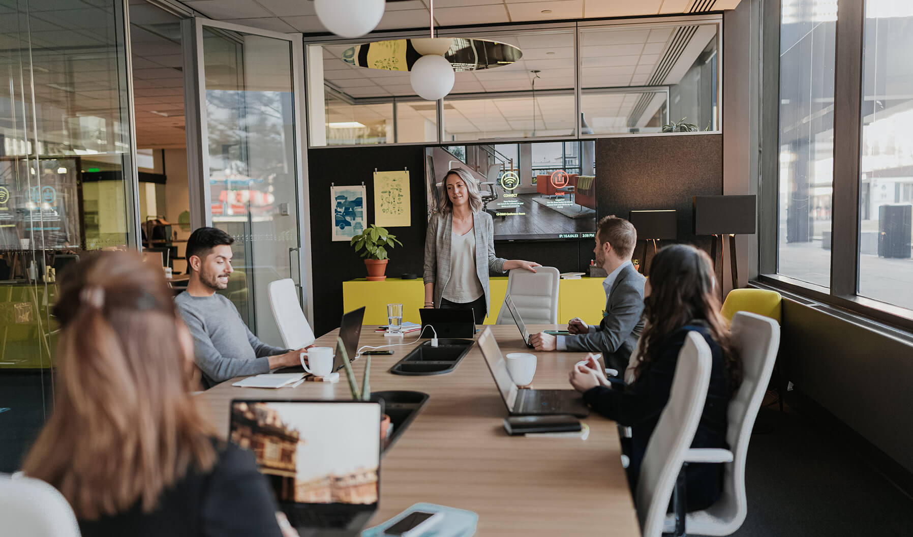 This meeting space supports collaboration as well as a warm and inviting culture within the workplace. The layer of pendant lighting and floor lighting add another layer beyond the great natural light this space offers.