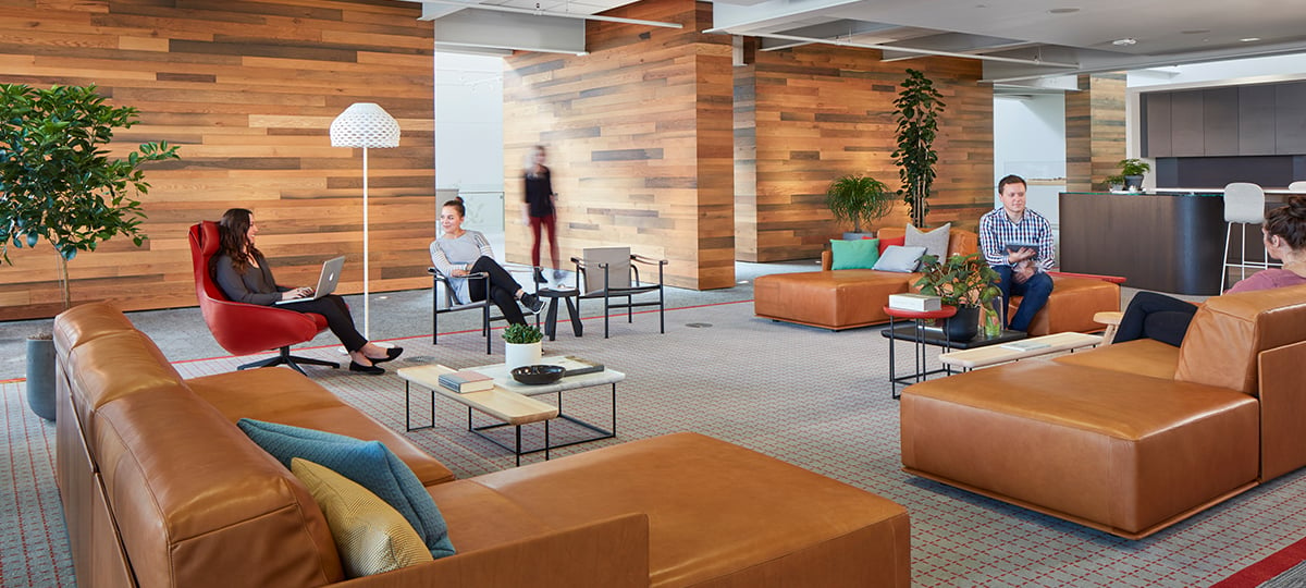 This lounge creates a Social Space that provides comfortable seating to encourage interaction and collaboration with relaxed, seated postures. An accent wall created by wood harvested from local Michigan sources is nod to Haworth heritage and culture.