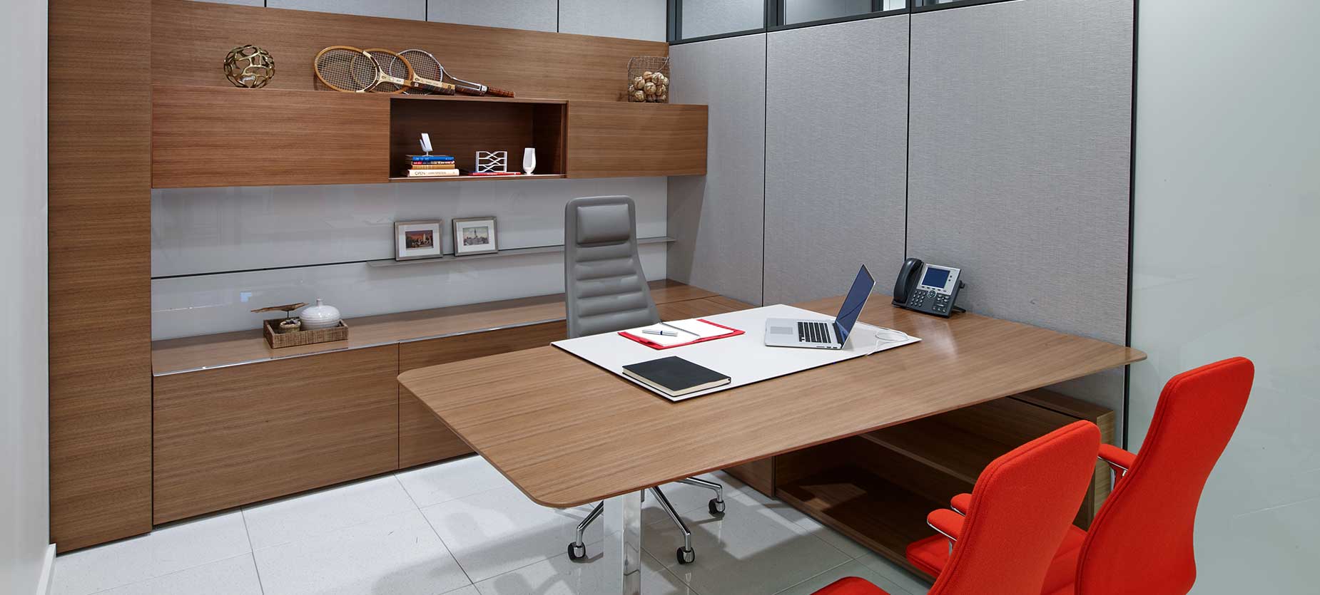 Suite private office offers a look of prestige and functionality, including a height adjustable table and power access within the work surface. Seating includes the Lotus high-back executive armchair and Lotus mid-back chairs.