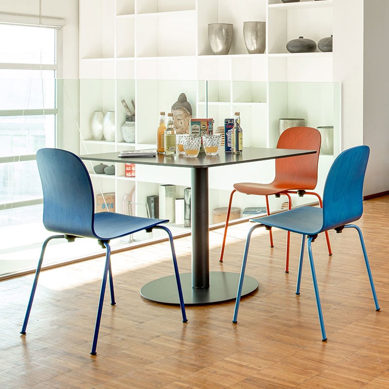 Haworth Tate chairs in red and blue at a dining table
