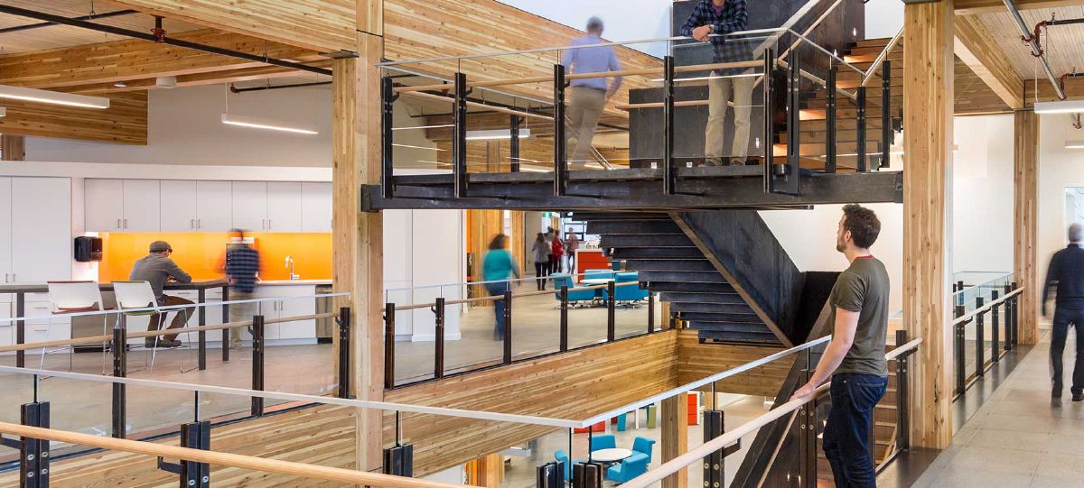 An atrium space with a feature stairway gives people connectivity and visibility right in the heart of the building’s 112,000 square foot space, enabling sight lines and connection among people.