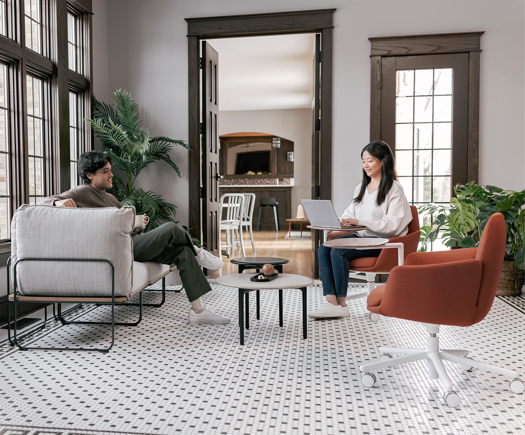 Haworth Poppy guest chair in dark rust upholstery with white swivel base