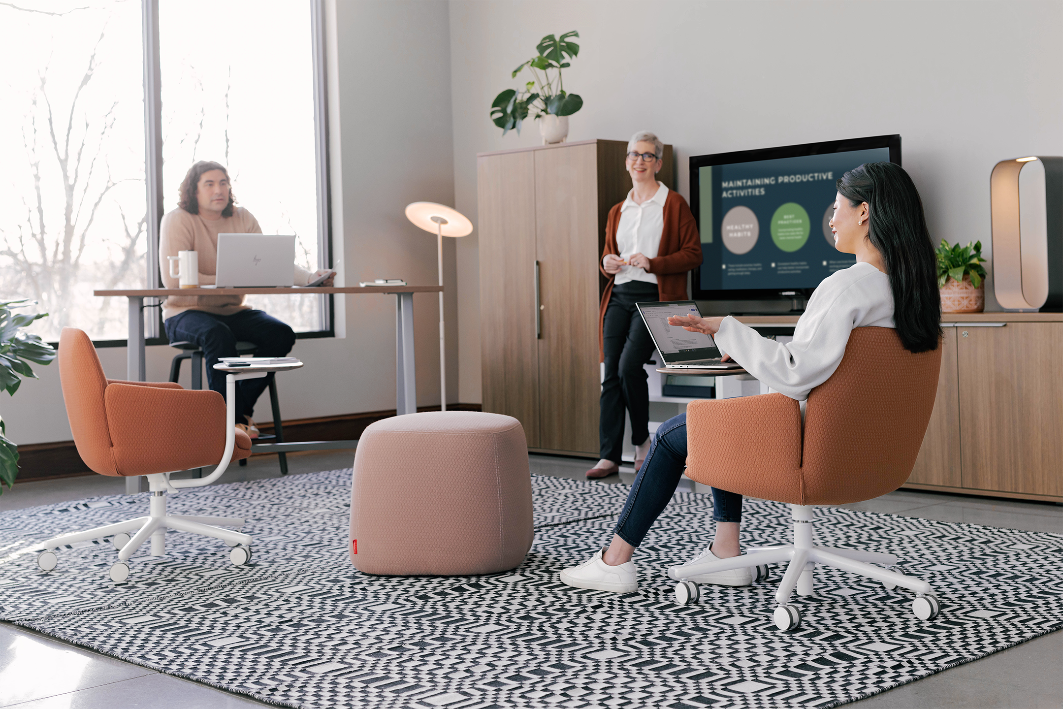 Haworth Poppy guest chairs with white swivel base and dark brown upholstery in a office room