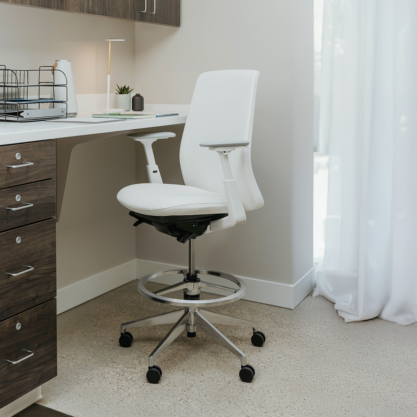 Soji Cleanable Task Stool in a healthcare environment featuring X-Series storage.