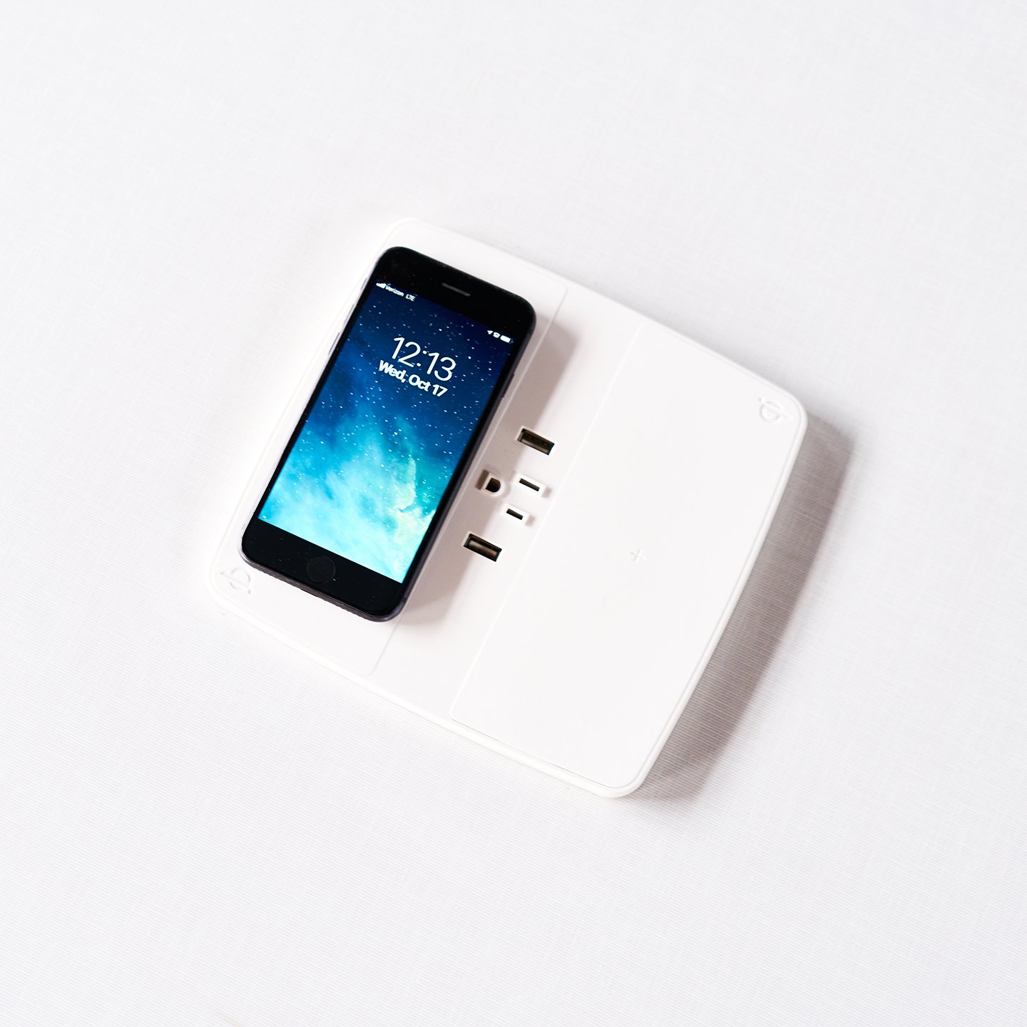 Haworth Collaborative Power Accessories on a desk with a phone wireless charging on the pad