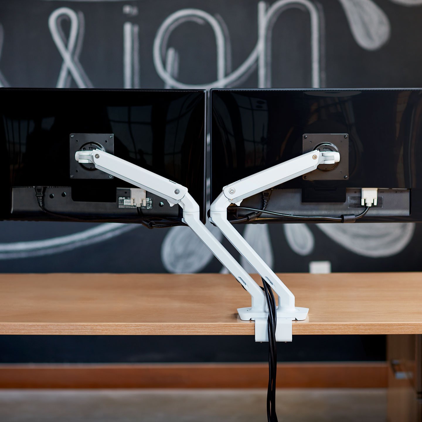 Haworth Monitor Arm Accessories on a desk with dual monitor arms and cable hiders