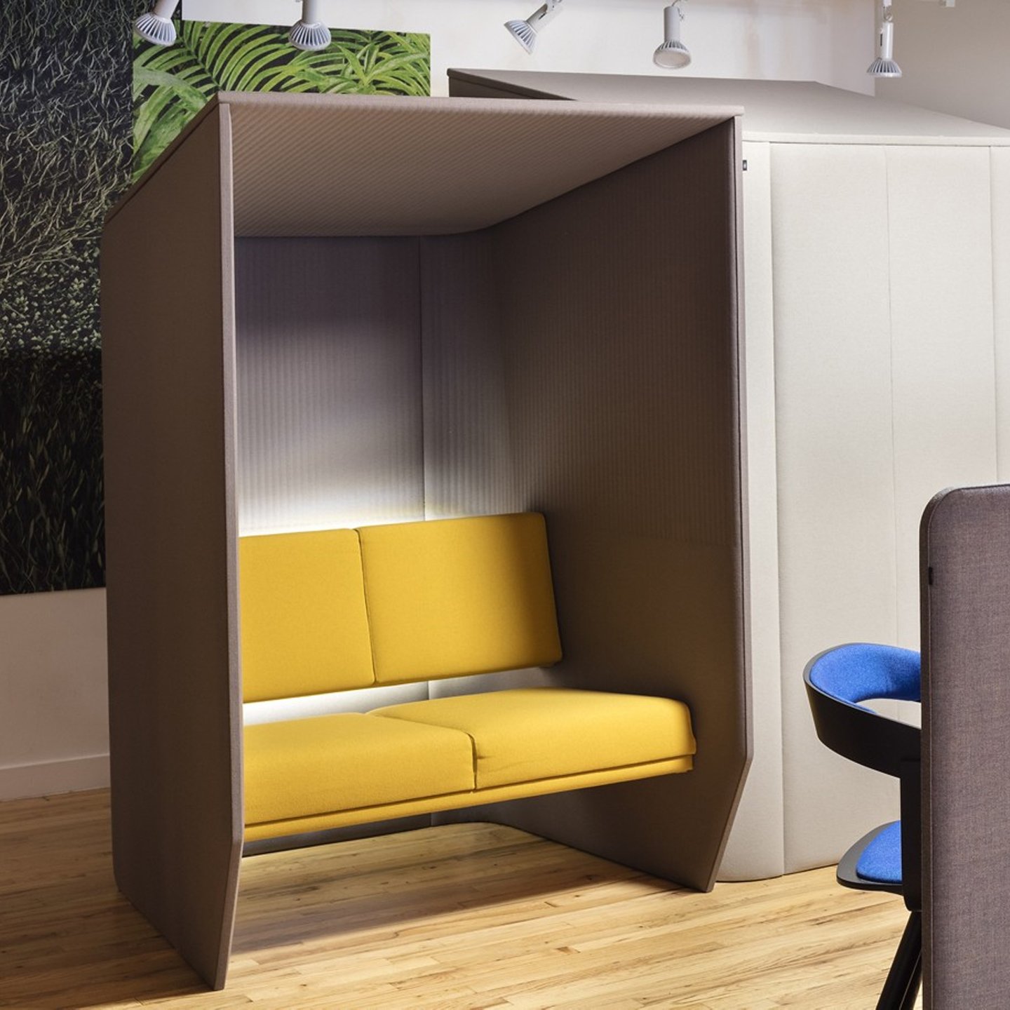 Haworth BuzziHub Booth in brown color with yellow chair fabric in office space