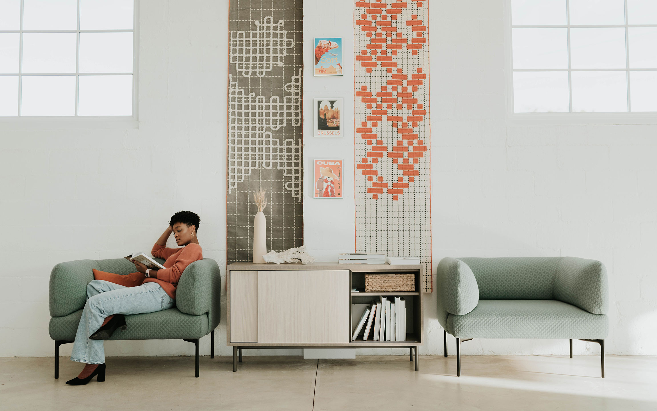 Haworth Cabana Lounge in green color with employee siting in it in open office space