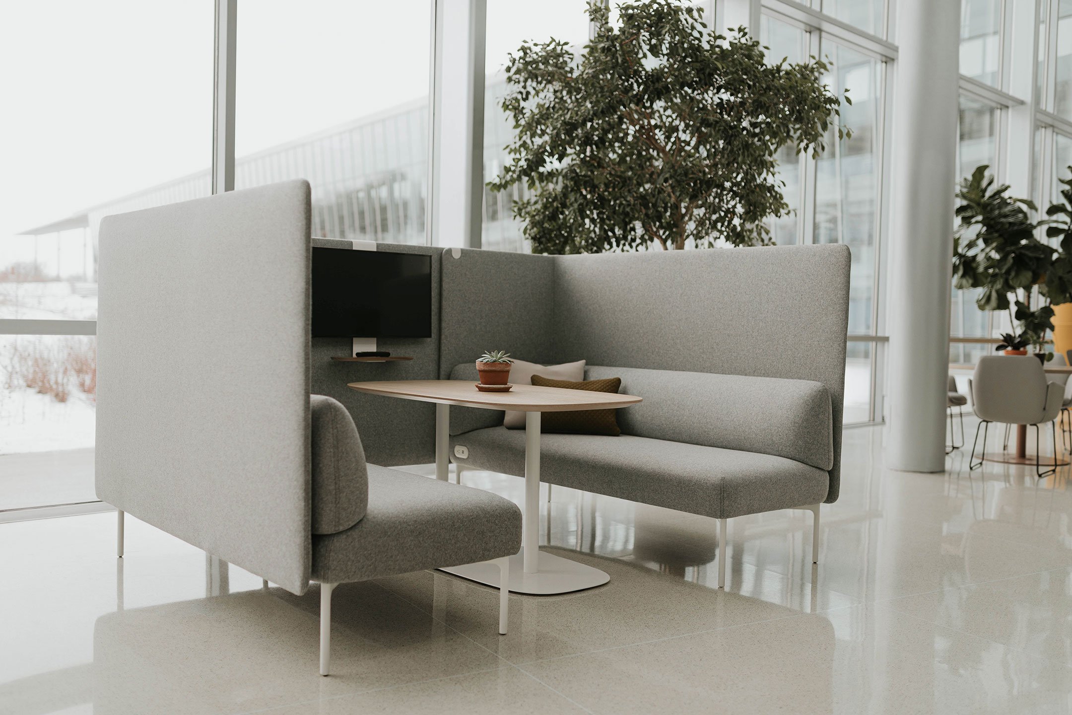 Haworth Cabana Lounge in grey color with table in center for collaboration in open office space