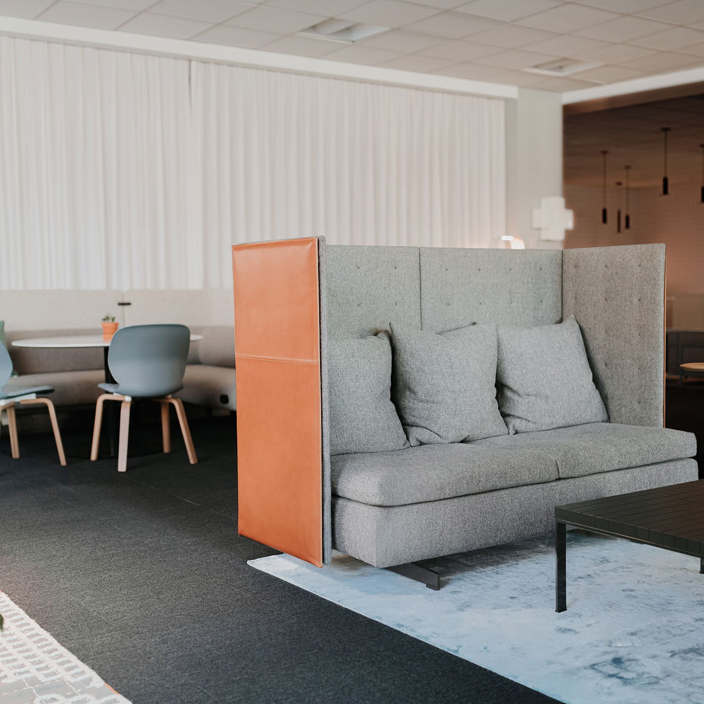 Haworth GranTorino HB Booth in grey color and orange back in open office lounge area