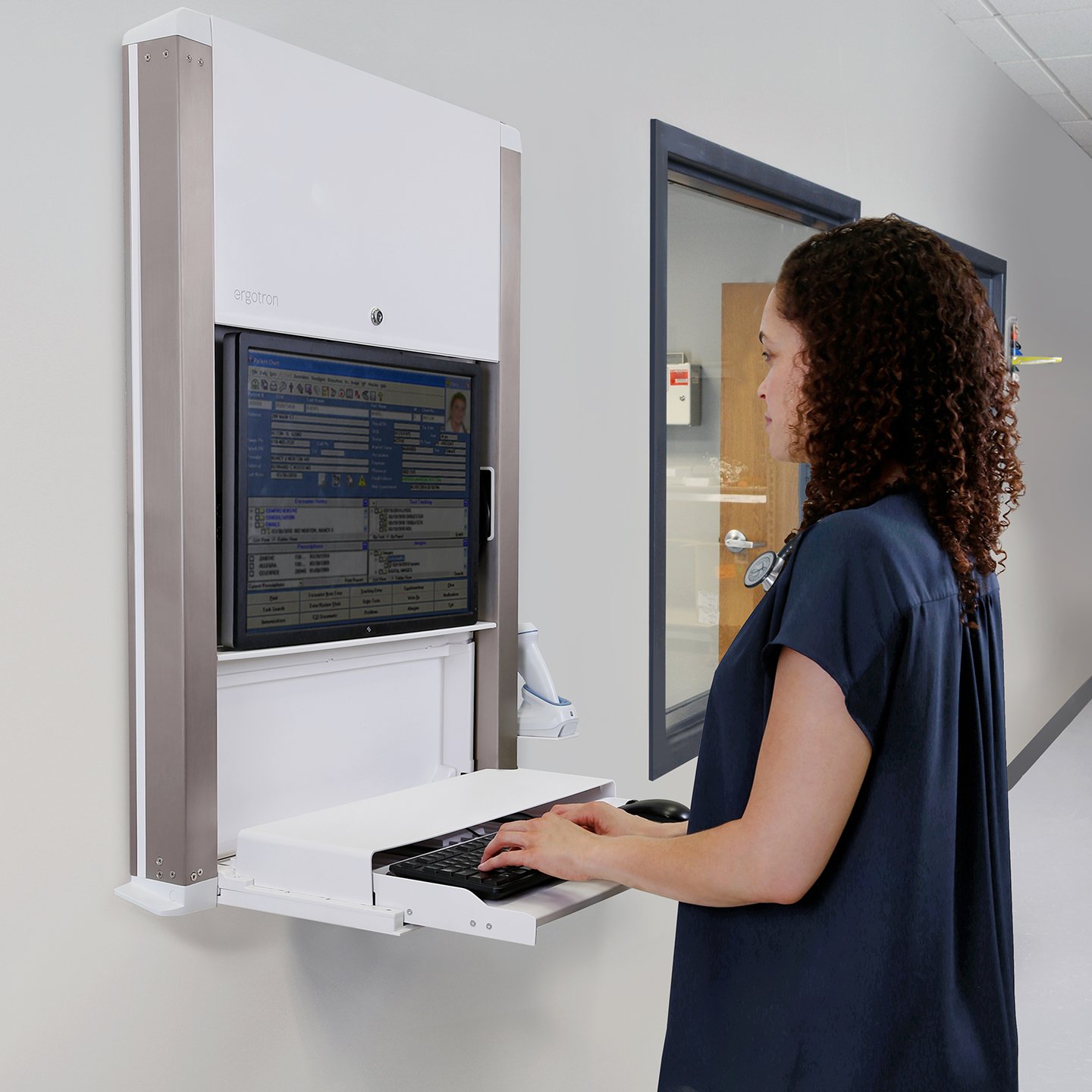 Haworth Carefit Enclosure Workspace in hospital hallway being used by staff in white color