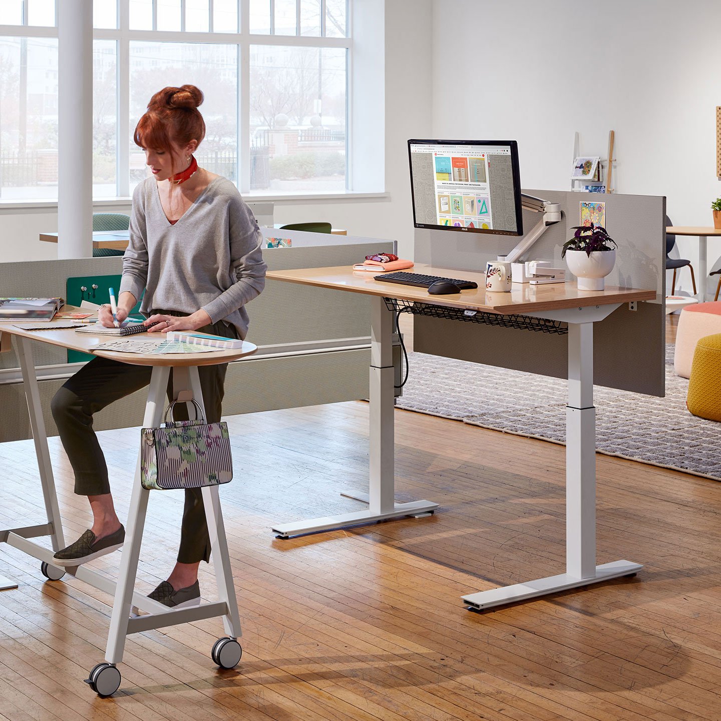 Haworth Compose Beam Workspace Divider in office area with employee on adjustable height desk in office