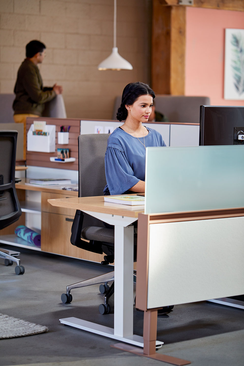 Haworth Compose Connections workspace divider in office space with employee working at desk with monitor