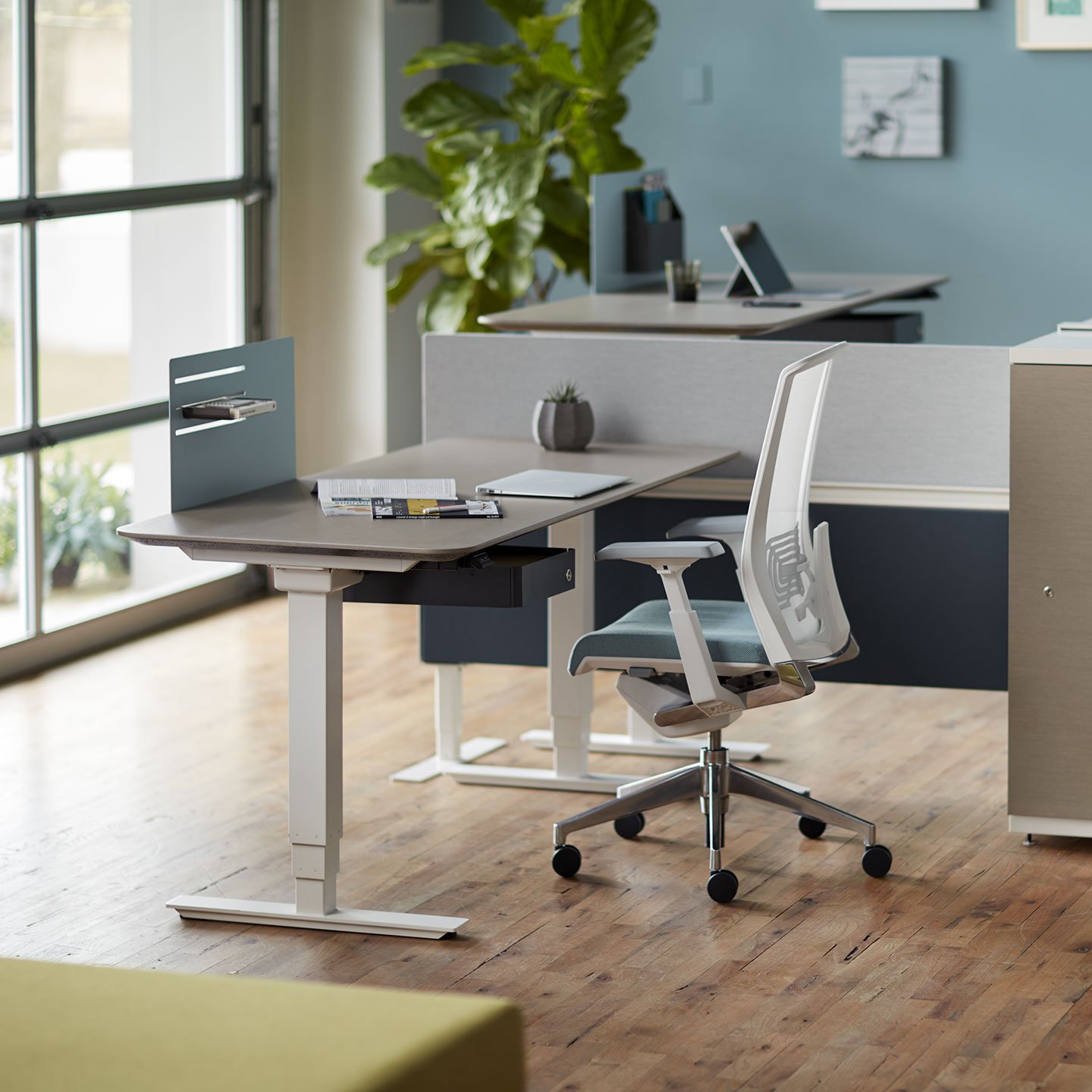 Haworth Compose Connections workspace divider in grey in an office space with height adjustable table and chair 