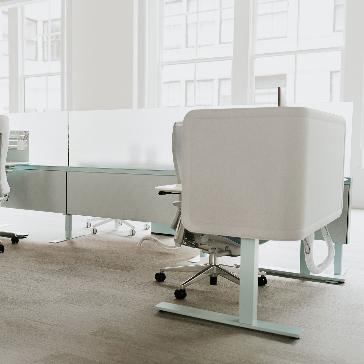 Haworth Compose Connections workspace divider in white in office space with white chairs and white desks