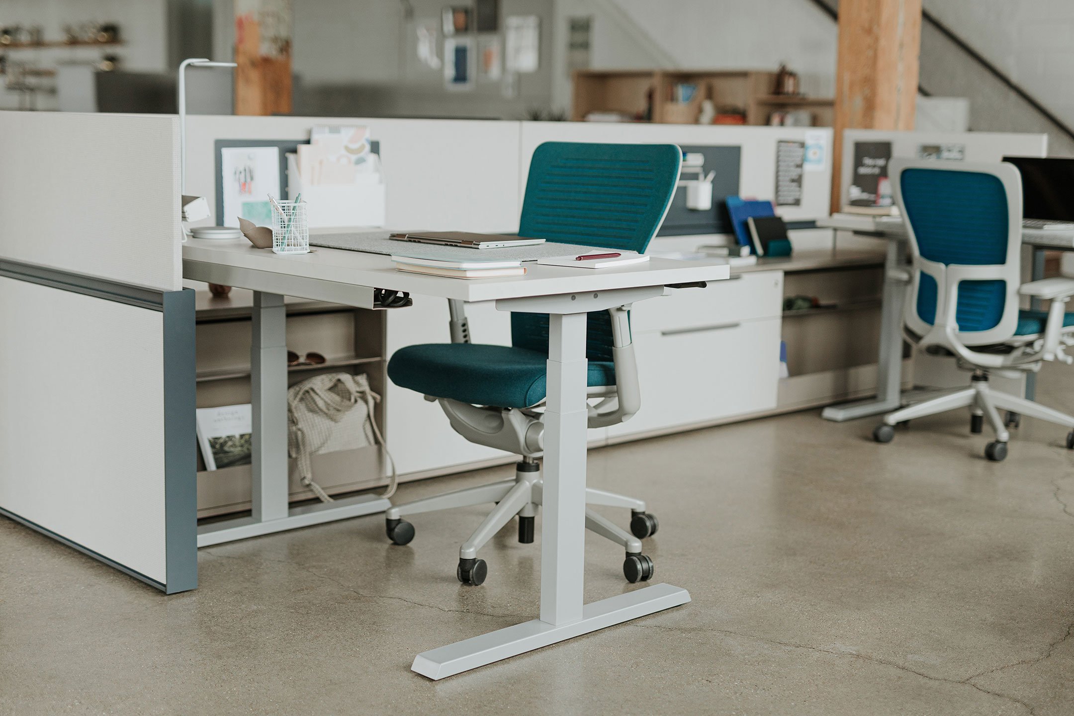 Haworth Compose Workspace in office space with privacy divider in middle and open front with height adjustable desk