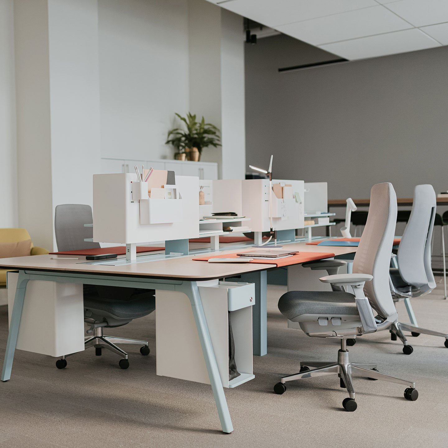 Haworth Intuity Workspace Divider in office setting with desk that have storage under them and haworth fern chairs