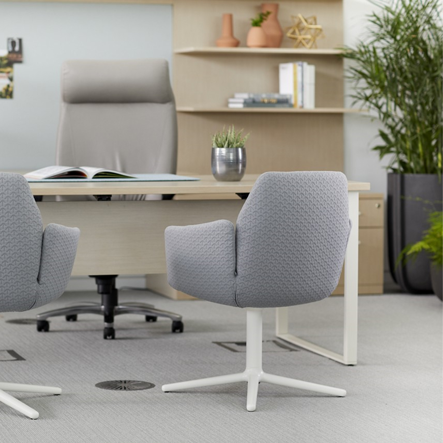 Haworth Masters Series Workspace veneer desk in private office with shelving space and grey chairs