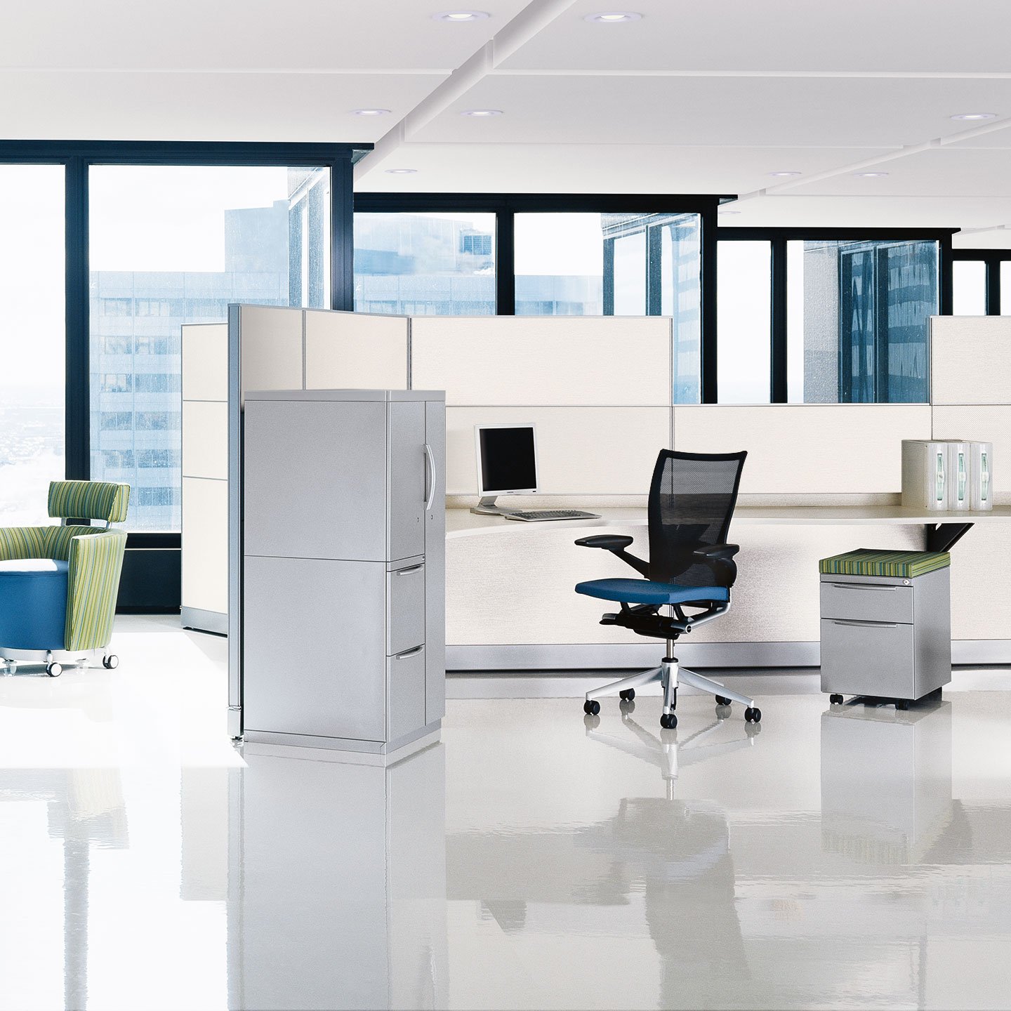 Haworth Unigroup Too Workspace in open office area with white desk and grey aluminum storage space with windows over looking city