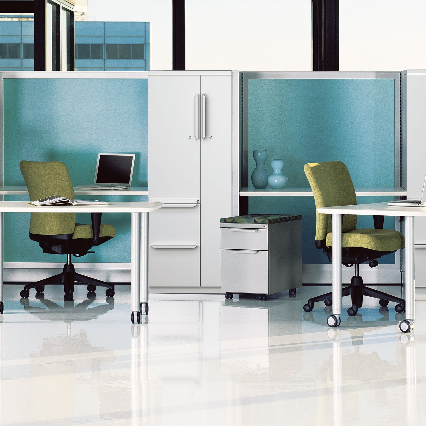 Haworth Unigroup Too Workspace with white desks and storage space with green chairs at desk in office