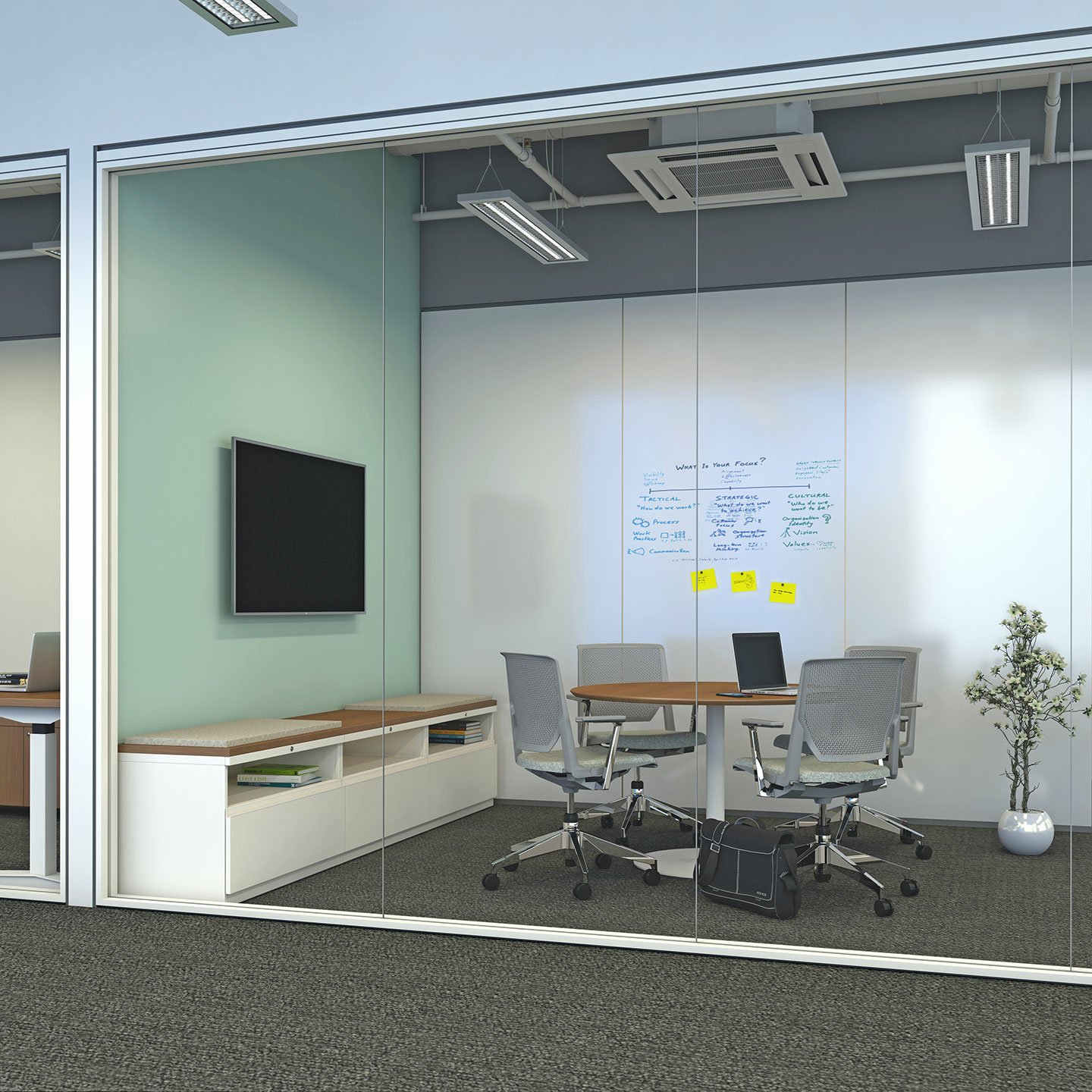 Haworth X Series Desks in laminate color in private conference room for collaboration with whiteboard and monitor on wall