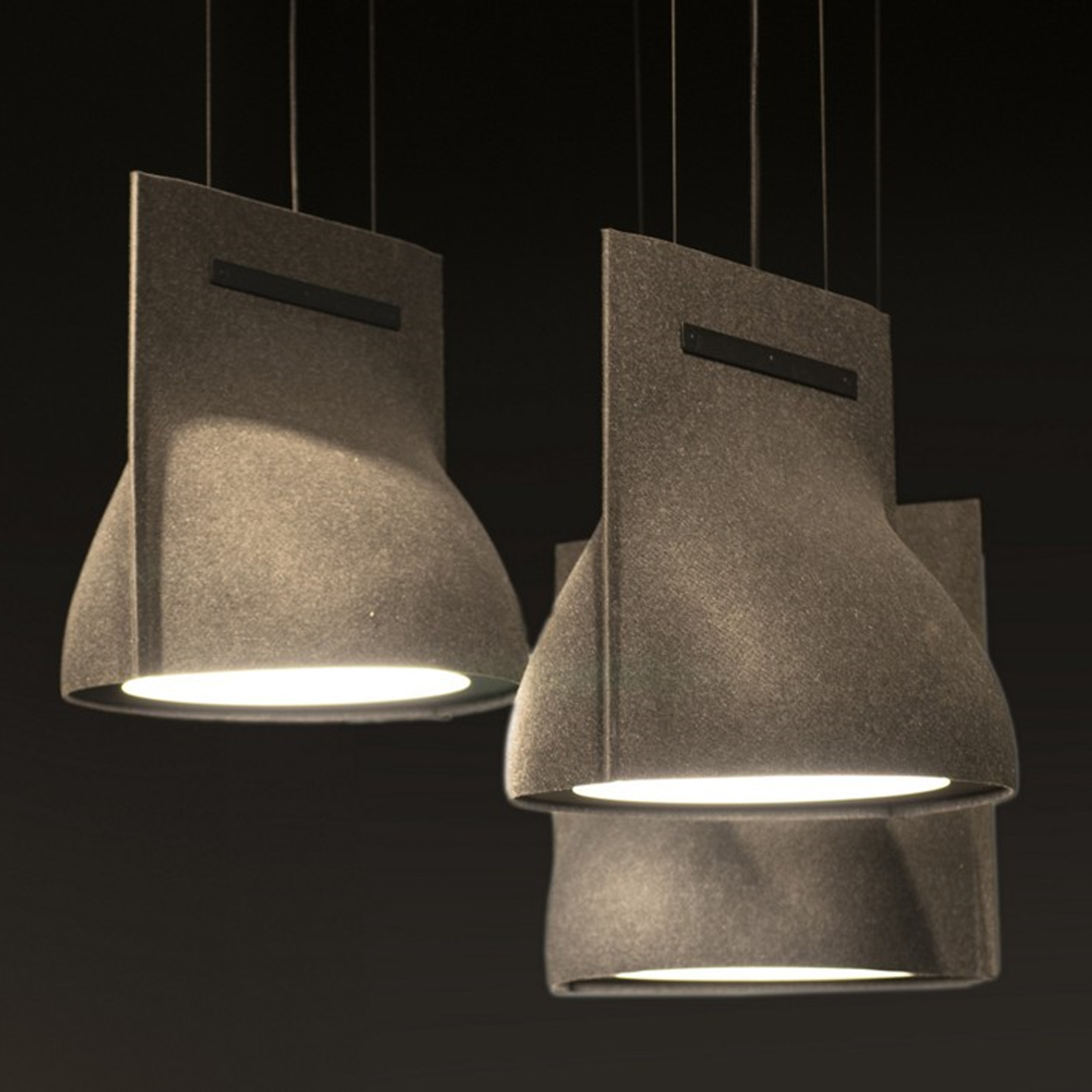 Haworth BuzziBell Lighting in felt in dark room with 3 lights hanging down from ceiling
