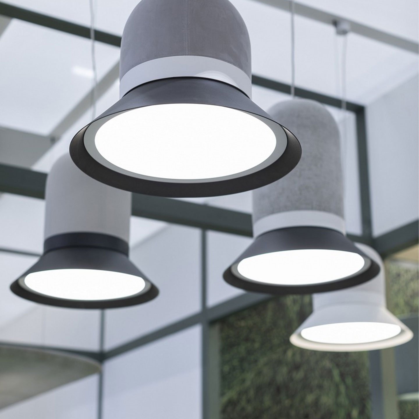 Haworth BuzziHat Lighting with grey felt top and black steel disc hanging from an office ceiling