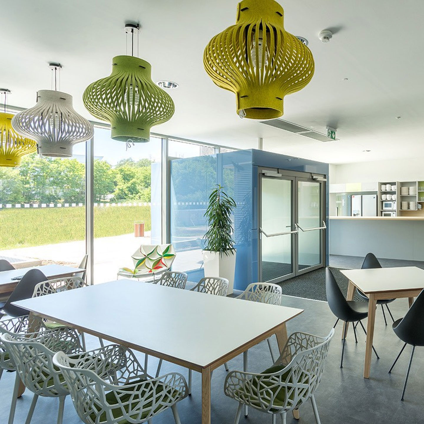 Haworth BuzzilLight Mono Lighting in yellow, white, and green in coffee shop with tables and chairs