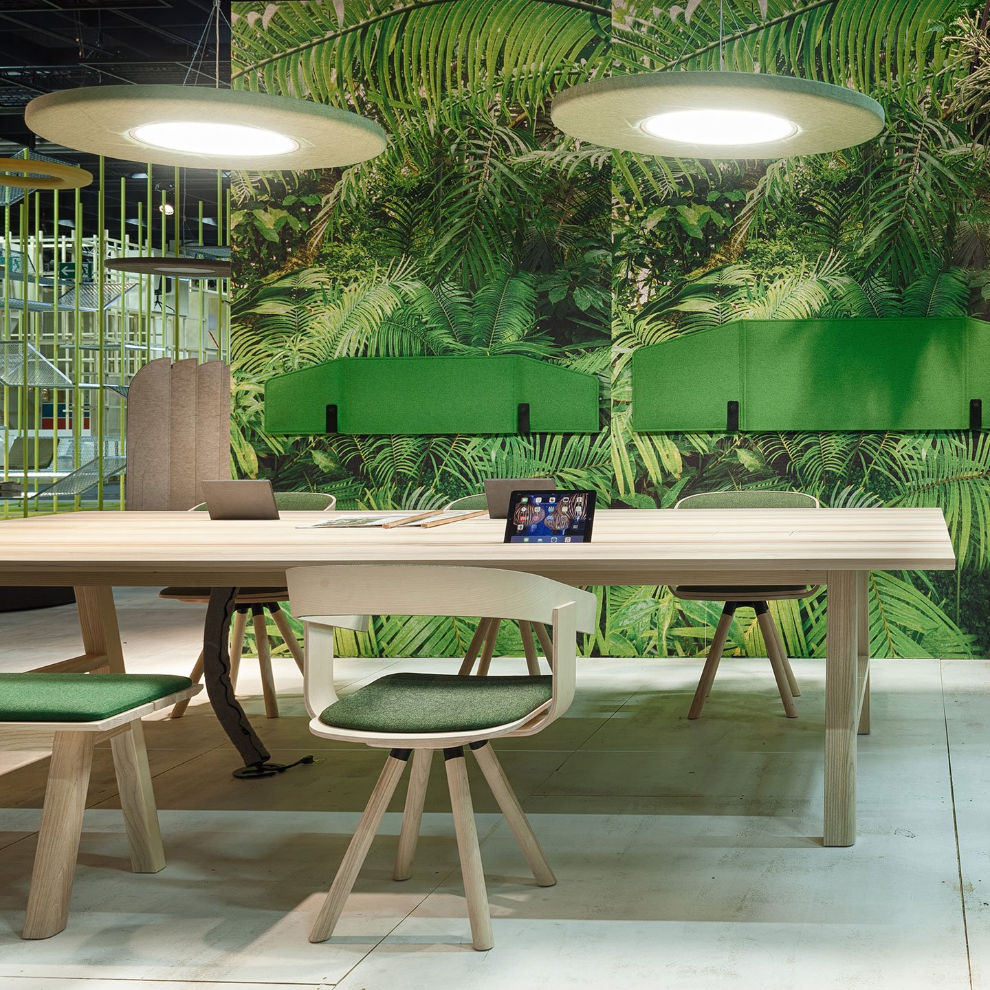 Haworth Buzzimoon lighting in green color above light wood desk with forest wall 