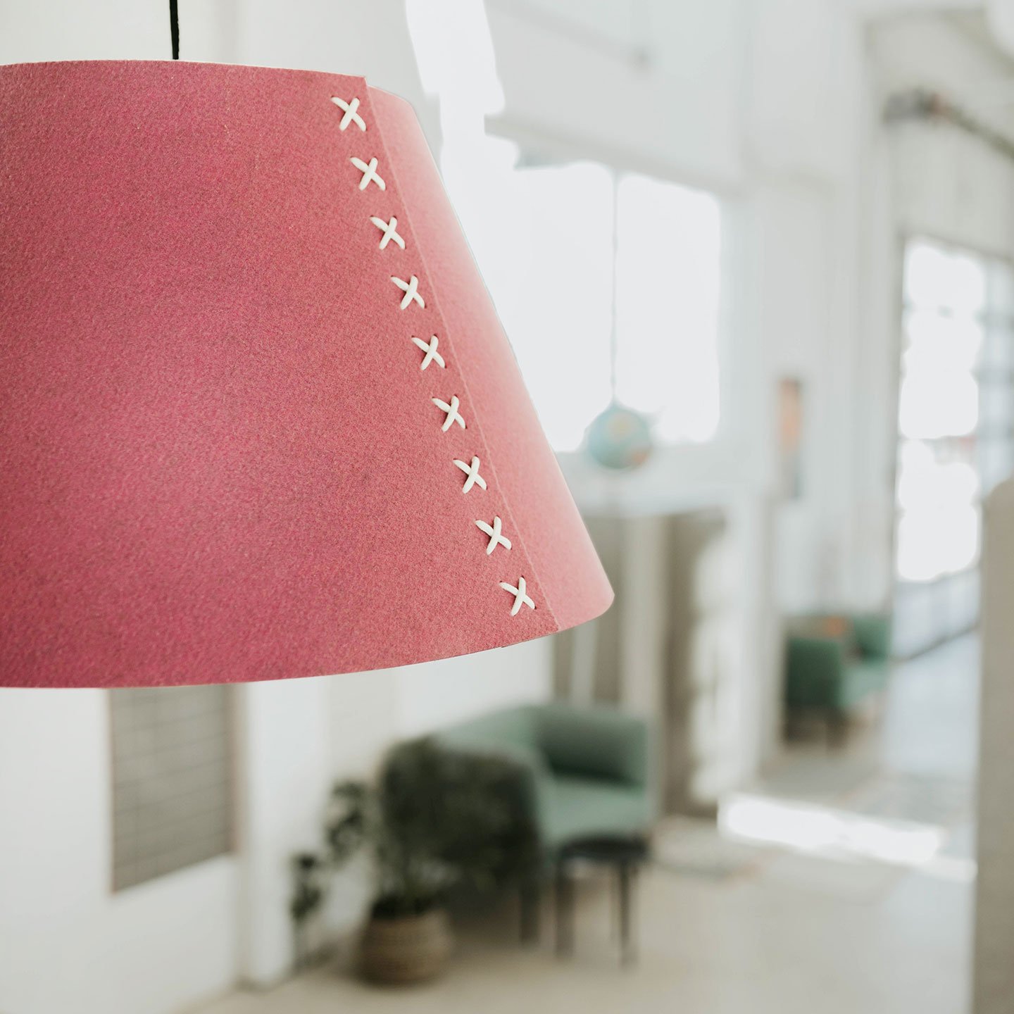 Haworth BuzziShade Lighting in pink in an office space hanging from ceiling