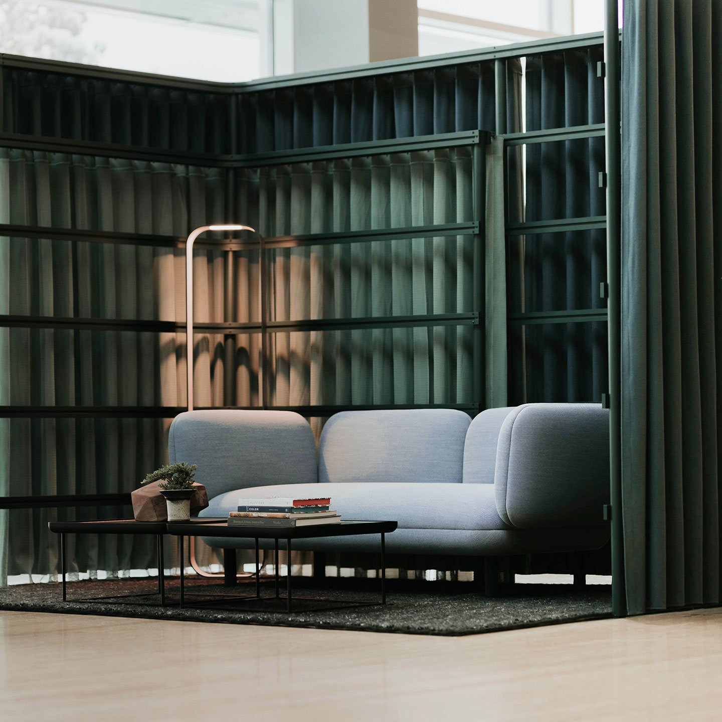 Haworth Contour Lighting in private lounge space with grey couch and wood coffee table