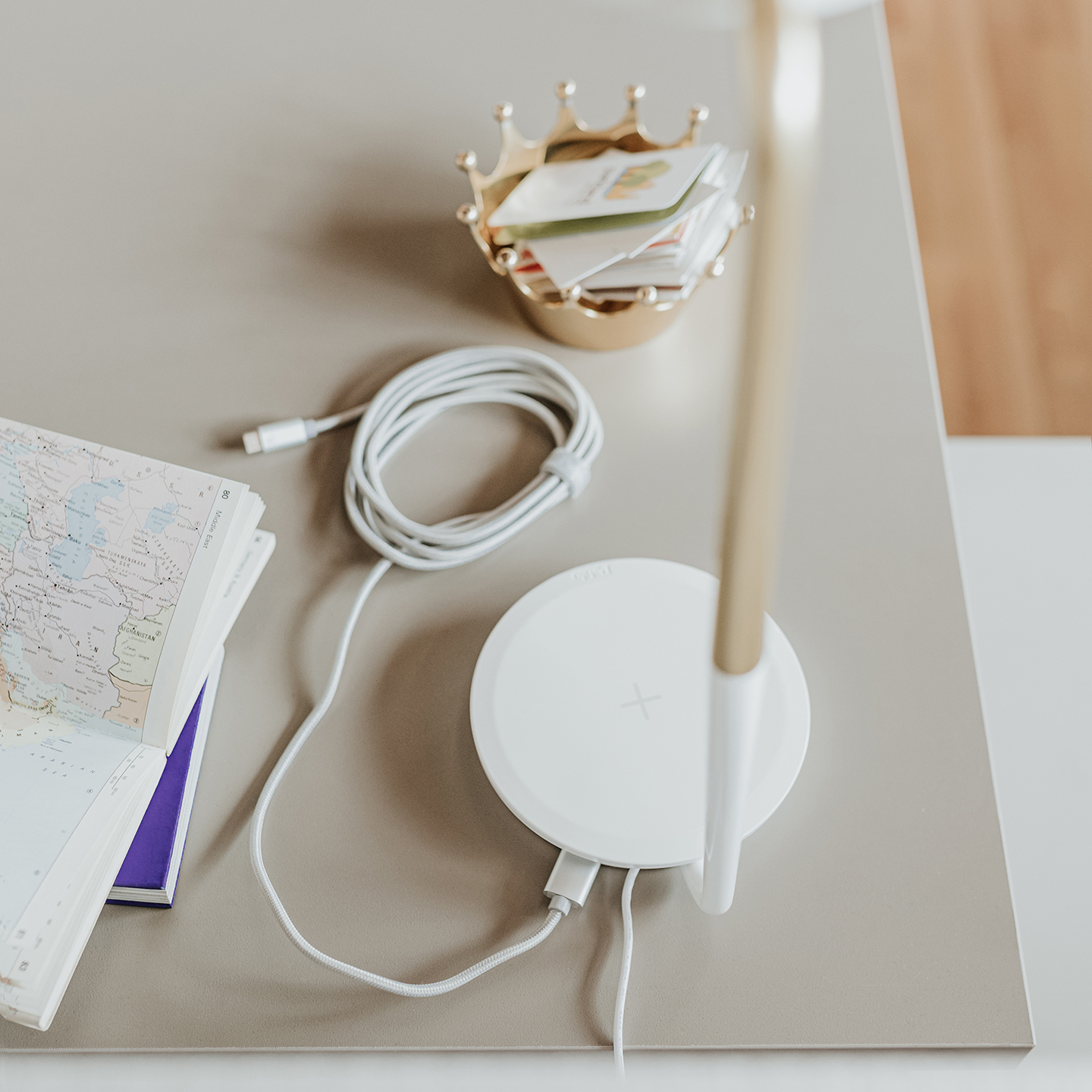 Haworth Pixo Plus Lighting white color on white desk with phone charger connected