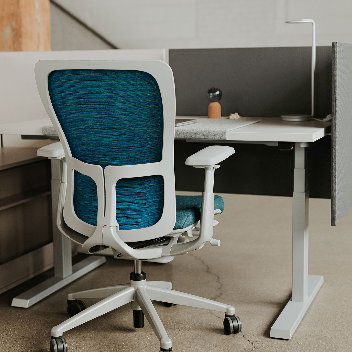 Haworth Pixo Lighting in white on height adjustable desk in blue chair 